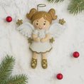 Load image into Gallery viewer, Decorative angel ornament with gold hair and shoes, surrounded by Christmas decorations on a white background.