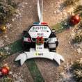 Load image into Gallery viewer, Personalized police car Christmas ornament featuring a black and white cop car design with BUSTED text, police lights and festive wreath detail. Customized with a name and year on the front banner. Glossy resin finish with bold black and white colors creates a fun and playful holiday look. Mostly 2D ornament with raised 3D details on the front only, lightweight and perfect for Christmas tree decor and police themed gifts.