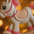 Load image into Gallery viewer, Toy horse with a pink bridle against a blurred light background