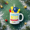 Load image into Gallery viewer, Personalized teacher ornament designed as a white mug filled with classroom tools including scissors ruler pencil and marker. The front reads Worlds Best Teacher with custom name personalization. Mostly 2D design with raised 3D tool details. A perfect Christmas ornament gift for teachers educators and school staff.