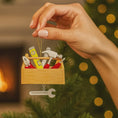Load image into Gallery viewer, Personalized handyman ornament featuring a wooden style toolbox filled with tools including hammer wrench pliers and level. Custom name and year displayed on the front. Mostly 2D design with raised 3D tool details on the surface. Perfect Christmas ornament for handyman contractors mechanics and skilled trade workers.