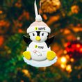 Load image into Gallery viewer, Personalized Baby Penguin First Christmas Ornament featuring a sweet penguin wearing a soft pink winter hat, sitting on a snowy base. The babyâs name is displayed on the hat and the year is placed on the belly, creating a meaningful keepsake for a newbornâs first holiday season. With bright yellow feet, soft winter details, and charming 3D design, this ornament is perfect for baby girls celebrating their very first Christmas and makes a thoughtful holiday gift for new parents.