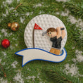 Load image into Gallery viewer, Golf-themed ornament with a golfer on a golf ball, surrounded by Christmas decorations.