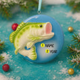 Load image into Gallery viewer, Decorative Bass fish ornament with customizable name and year on a blue background with Christmas elements.