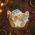 Load image into Gallery viewer, Personalized Baby First Christmas Ornament featuring a sweet newborn tucked inside a cozy woven basket with a soft blue star hat and matching blanket. This 3D front design includes raised details, textured knit pattern, and adorable teddy bear accent, creating depth and charm. Name is displayed on the hat and year on the star. A heartfelt keepsake for babyâs first holiday, nursery decor, or newborn gift. Perfect Christmas tree ornament for new parents.