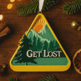 Load image into Gallery viewer, Decorative ornament with mountain design and 'GET LOST' text on a wooden surface with Christmas decorations.