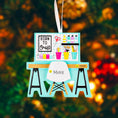 Load image into Gallery viewer, Born to Craft ornament featuring a creative desk scene with colorful craft supplies including scissors paint bottles brushes pencils and storage cups. The ornament showcases a playful crafting workspace design with a modern chair and desk setup. Made from durable resin with a detailed 3D front and flat 2D back for smooth hanging. Includes free handwritten personalization making it a perfect gift for crafters artists DIY lovers and creative kids. Ideal for Christmas trees craft rooms studios and handmade the