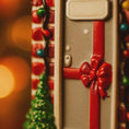 Load image into Gallery viewer, Close-up of a suitcase with a red bow, surrounded by festive lights and decorations.