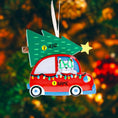 Load image into Gallery viewer, Festive cat themed Christmas ornament featuring a cheerful kitty riding in a red car with a decorated Christmas tree on top. Designed with playful holiday colors and a joyful winter atmosphere, this ornament adds a fun and cozy touch to any Christmas tree. Includes personalization options for name and year, making it a unique keepsake for cat lovers and pet themed holiday decor.