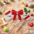 Load image into Gallery viewer, Festive pet themed Christmas ornament designed in a bone shape with a red holiday bow and paw detail. Featuring classic Christmas colors and a warm seasonal background, this ornament adds a joyful and loving touch to pet themed Christmas tree decor. Designed to be personalized with a name and year, making it a meaningful keepsake for pet owners and animal lovers.