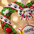 Load image into Gallery viewer, Personalized kitty Christmas ornament designed as a festive heart shaped wreath decorated with cat paw prints fish details and cozy holiday accents. The ornament includes a hanging heart tag that can be personalized with your cat’s name and year. Styled in a warm Christmas setting with soft snow texture and festive colors making it perfect for cat lovers holiday decor cat memorial keepsake and Christmas tree display.