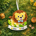 Load image into Gallery viewer, A cute lion themed Christmas ornament designed with a playful and colorful style, perfect for kids and animal lovers. This ornament features a friendly lion character standing on a grassy base with a glossy finish and cheerful details. The design includes a personalization option, allowing a custom name and year to be added, making it a meaningful keepsake for children or family holiday traditions. Ideal for Christmas trees, nursery decor, or as a unique personalized gift for animal themed celebrations.