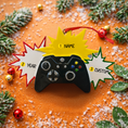 Load image into Gallery viewer, Personalized gamer controller Christmas ornament featuring a raised 3D front with detailed game controller design, including realistic buttons, joystick elements, and bold comic style accents. The ornament has a smooth flat 2D back for easy hanging and long lasting durability on the Christmas tree. The design allows personalization with a name and year clearly displayed on the front, making it a unique holiday keepsake. Bright colors and gaming themed details make this ornament perfect for kids, teens, and