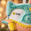 Load image into Gallery viewer, Personalized sewing machine ornament featuring a charming vintage style design with soft pastel colors and floral details. The ornament includes space for a name and year, making it a meaningful keepsake gift. Crafted from durable resin with a detailed 3D raised front and flat 2D back for smooth hanging. Includes free handwritten personalization. A perfect Christmas ornament gift for grandmothers sewing lovers quilters crafters and anyone who enjoys handmade traditions and creative hobbies.