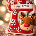 Load image into Gallery viewer, Personalized baking ornament featuring a festive red stand mixer design with snowflake details and a cute reindeer bowl accent. Finished with a smooth glossy surface and holiday inspired colors. Includes free handwritten personalization with one name and year displayed on the mixer. Designed with a raised 3D front and flat back for easy hanging. Styled in a cozy Christmas setting with snow greenery and ornaments, perfect for bakers home cooks and holiday keepsakes.