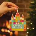 Load image into Gallery viewer, Colorful 'Master Builder' toy block castle held by a hand with a warm, blurred background.