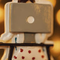 Load image into Gallery viewer, Close-up of a ceramic dice with a light switch mechanism on a blurred background