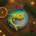 Load image into Gallery viewer, Decorative fish ornament on a round blue plate with Christmas decorations around