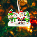 Load image into Gallery viewer, Personalized Christmas ornament with Santa Claus, elf, snowman, and penguin on a blurred Christmas tree background.