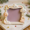 Load image into Gallery viewer, Decorative photo frame with cloud and rainbow design on a marble surface.