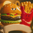 Load image into Gallery viewer, Toy hamburger with a face and smiling fries on a chair