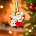 Load image into Gallery viewer, Decorative Christmas ornament of Santa Claus with a 'Nice List' sign against a festive background.