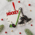 Load image into Gallery viewer, Hockey-themed Christmas ornament with skates, stick, and 'HOCKEY' text on a light gray background.