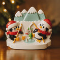 Load image into Gallery viewer, Decorative ornament with penguins and a duck in a snowy scene, Christmas tree in the background.