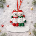 Load image into Gallery viewer, Two snowman ornaments on a white background with Christmas decorations.