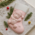 Load image into Gallery viewer, Pink Christmas stocking with a bear design on a decorative surface with greenery and ornaments.