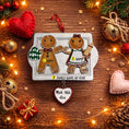 Load image into Gallery viewer, Personalizable gingerbread couple ornament on a wooden surface with festive decorations.