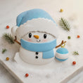 Load image into Gallery viewer, Personalized Snowman Baby Christmas Ornament featuring a cheerful snowman with blue glitter hat and scarf, holding a sparkling ornament. This design has a raised 3D front with textured details, dimensional elements, and vibrant winter colors. The child’s name is placed on the scarf and the year is added below. A perfect keepsake for baby’s first Christmas, newborn gift, winter holiday decoration, and meaningful family tree memory ornament.