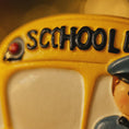 Load image into Gallery viewer, Close-up of a toy school bus with 'SCHOOL' on the front.