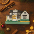 Load image into Gallery viewer, Decorative house ornament on a wooden surface with cinnamon sticks and Christmas decorations.