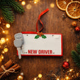 Load image into Gallery viewer, Decorative license plate with 'NEW DRIVER' text on a wooden surface with Christmas decorations.