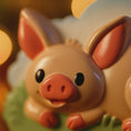 Load image into Gallery viewer, Close-up of a cartoonish pig figurine with a blurred background