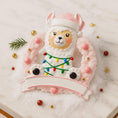 Load image into Gallery viewer, Personalized pink llama Christmas ornament featuring a cute white llama wrapped in colorful holiday lights, framed in a glittery wreath with pink accents. The top hat band can be customized with a name, while the bottom banner allows space for year or Babyâs 1st Christmas. Designed in soft pink and festive tones, this resin baby girl Christmas ornament makes a meaningful keepsake gift for celebrating a newbornâs first holiday season.