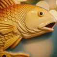 Load image into Gallery viewer, Close-up of a goldfish-shaped object with a blurred background