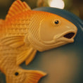 Load image into Gallery viewer, Close-up of a yellow fish-shaped object on a blue background
