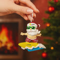 Load image into Gallery viewer, Personalized surfing Santa Christmas ornament featuring a fun beach themed Santa riding a wave on a surfboard. Raised 3D front details add depth while the back remains flat for easy hanging. Custom name and year placement make this ornament a playful and unique holiday keepsake for Christmas tree decor.