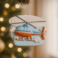 Load image into Gallery viewer, Decorative helicopter ornament hanging on a Christmas tree with blurred lights in the background.
