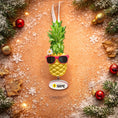 Load image into Gallery viewer, Pineapple ornament with sunglasses on a decorative background with Christmas elements