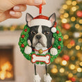Load image into Gallery viewer, Dog Christmas ornament in a wreath with a Santa hat against a festive background
