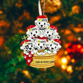 Load image into Gallery viewer, Personalized Christmas ornament with six dalmatians in a basket, each labeled with a name, on a blurred Christmas tree background.