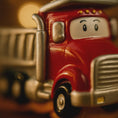 Load image into Gallery viewer, Close-up of a red ornament truck with a face on a blurred background