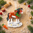 Load image into Gallery viewer, Horse-shaped Christmas ornament with a wreath and 'custom' text, surrounded by festive decorations.