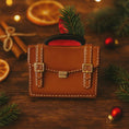Load image into Gallery viewer, brown briefcase ornament on a green surface with Christmas decorations
