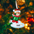 Load image into Gallery viewer, This ice skating girl ornament features a joyful winter character gliding on ice, wearing a festive red and green outfit with cozy winter details. The design highlights a playful skating pose, soft facial expression, and winter accessories that capture the magic of the holiday season. Personalized with a name on the hat and a year on the ice base, this ornament works beautifully as a Christmas tree decoration or winter keepsake gift for children and families.