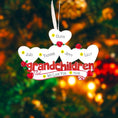 Load image into Gallery viewer, Decorative ornament with names of grandchildren on a blurred Christmas tree background