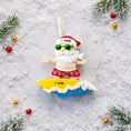 Load image into Gallery viewer, Personalized surfing Santa Christmas ornament featuring a fun beach themed Santa riding a wave on a surfboard. Raised 3D front details add depth while the back remains flat for easy hanging. Custom name and year placement make this ornament a playful and unique holiday keepsake for Christmas tree decor.